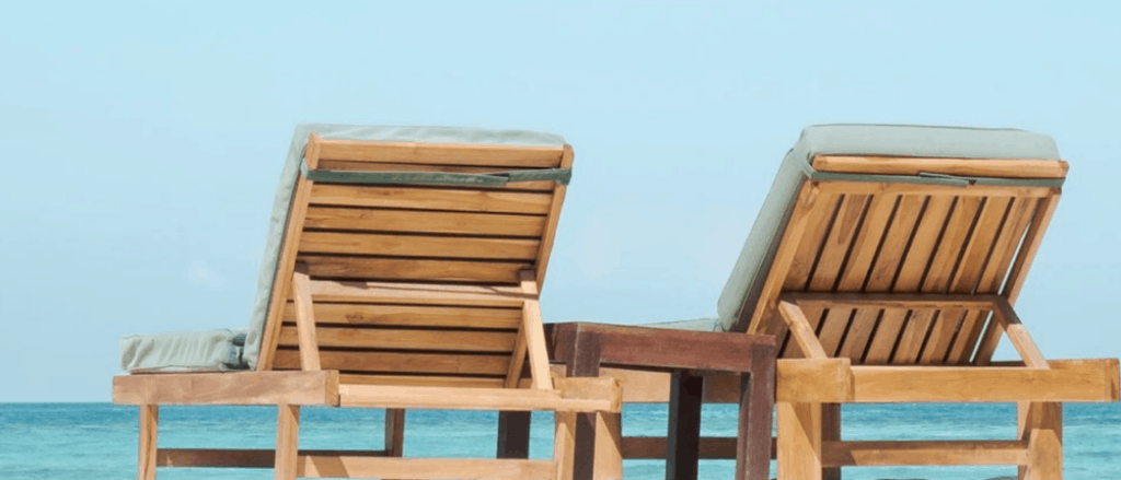 Image of two deck chairs facing a blue sea. Topic of the post is Taking a Blogging Break